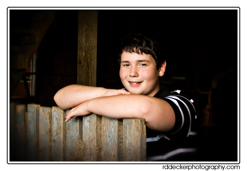 Ben strikes a pose in a rustic barn.